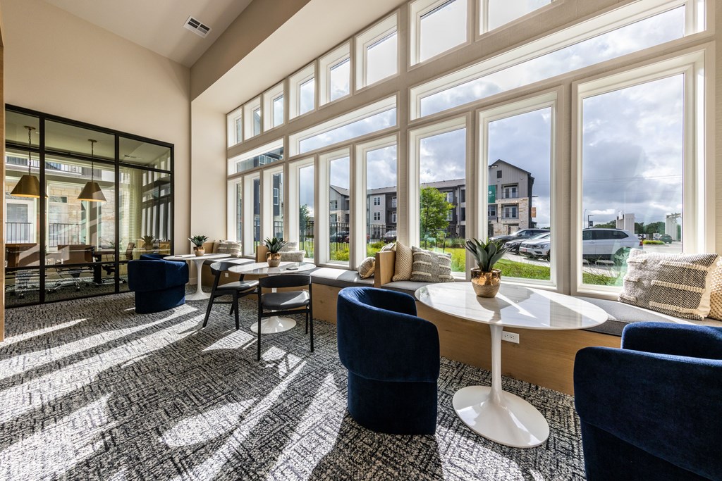 A sunny day in a modern living room with a view of the street outside.