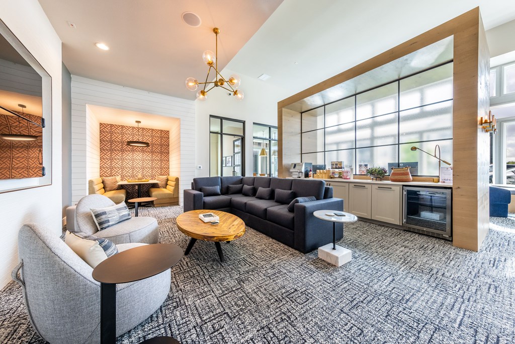 A modern living room with a grey sofa and a coffee table.