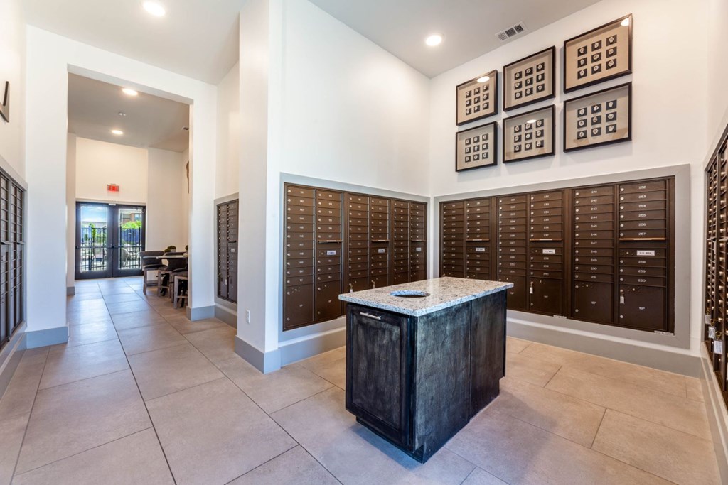 A reception area with a wooden reception desk and a wall of mailboxes.