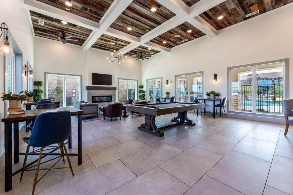 A spacious living room with a high ceiling and wooden beams.