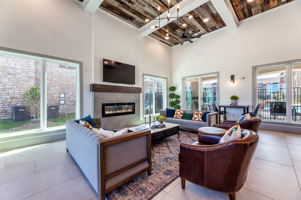 A modern living room with a fireplace and a flat screen TV.