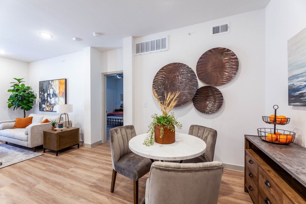 A dining room with a white table and chairs.
