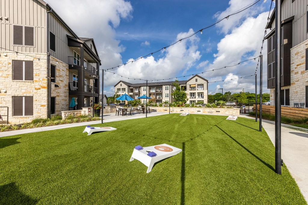 A grassy field with a white sign in the middle of it.