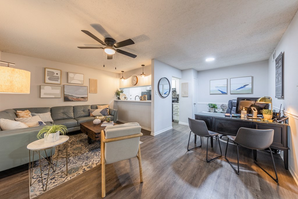a living room and dining room with a ceiling fan and hardwood floors