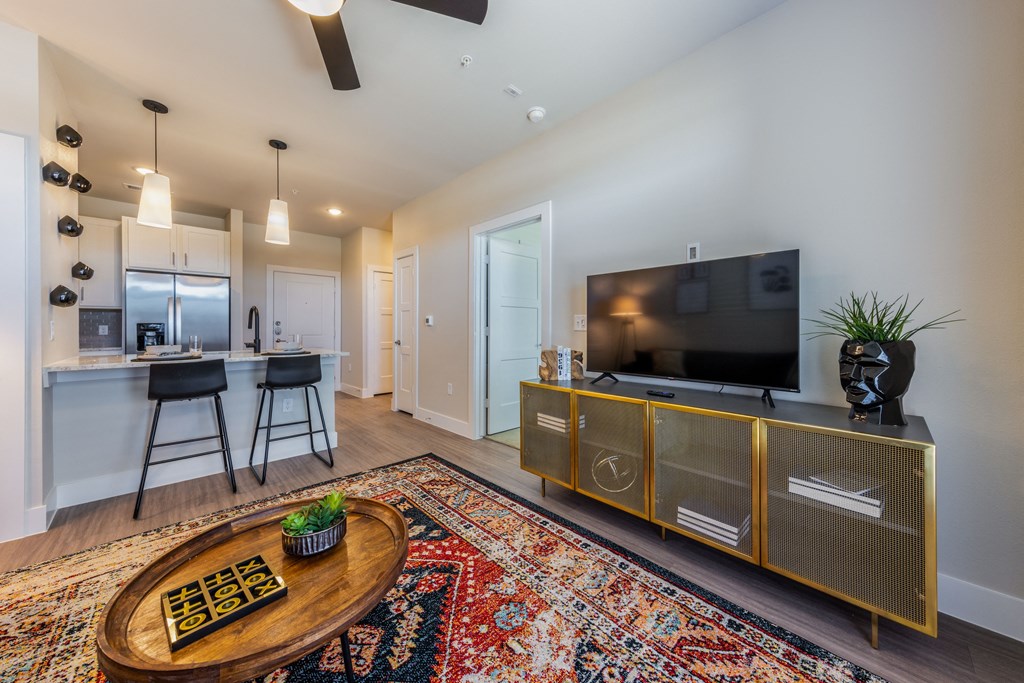 A modern living room with a flat screen TV and a wooden coffee table.