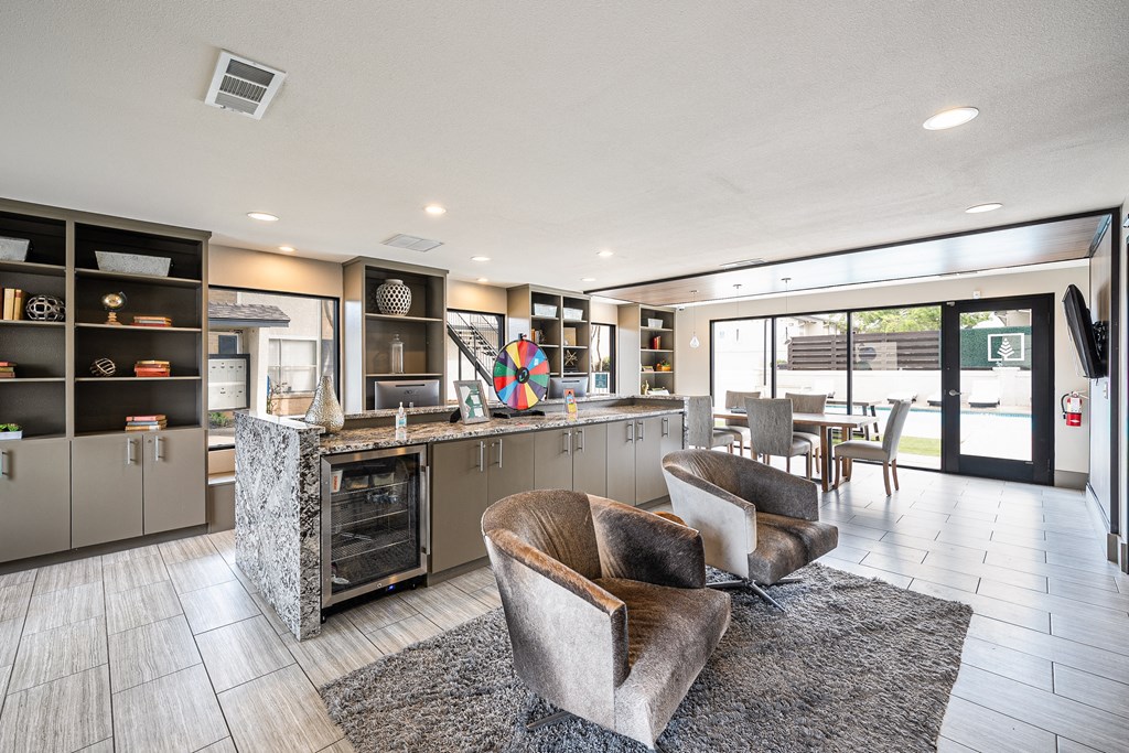 the preserve at ballantyne commons clubhouse with couches and chairs and a kitchen