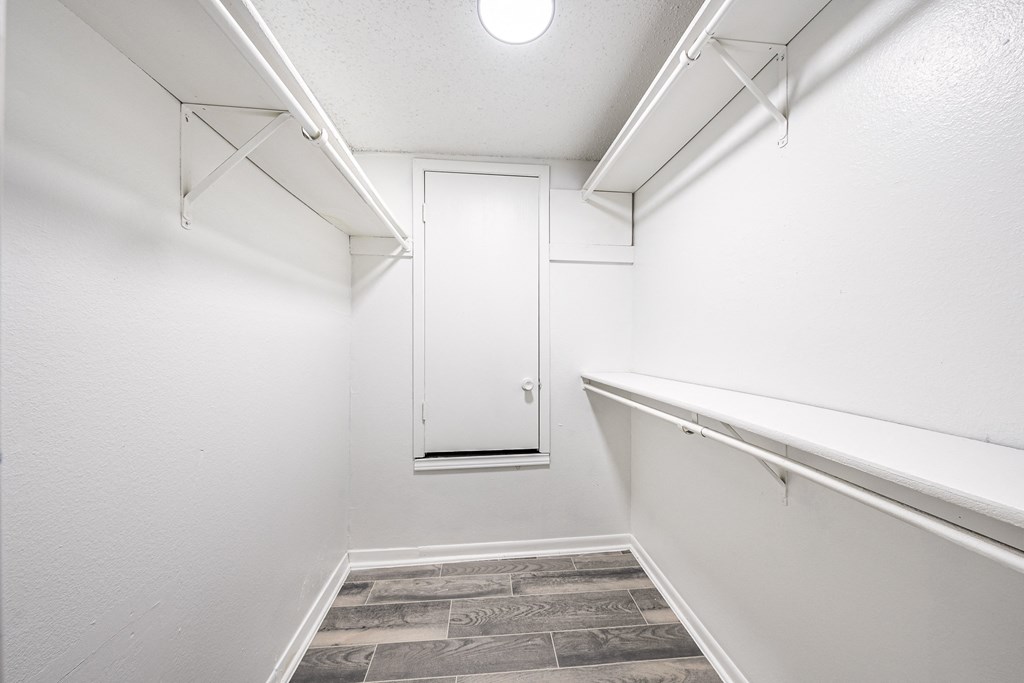 an empty room with white walls and a white closet