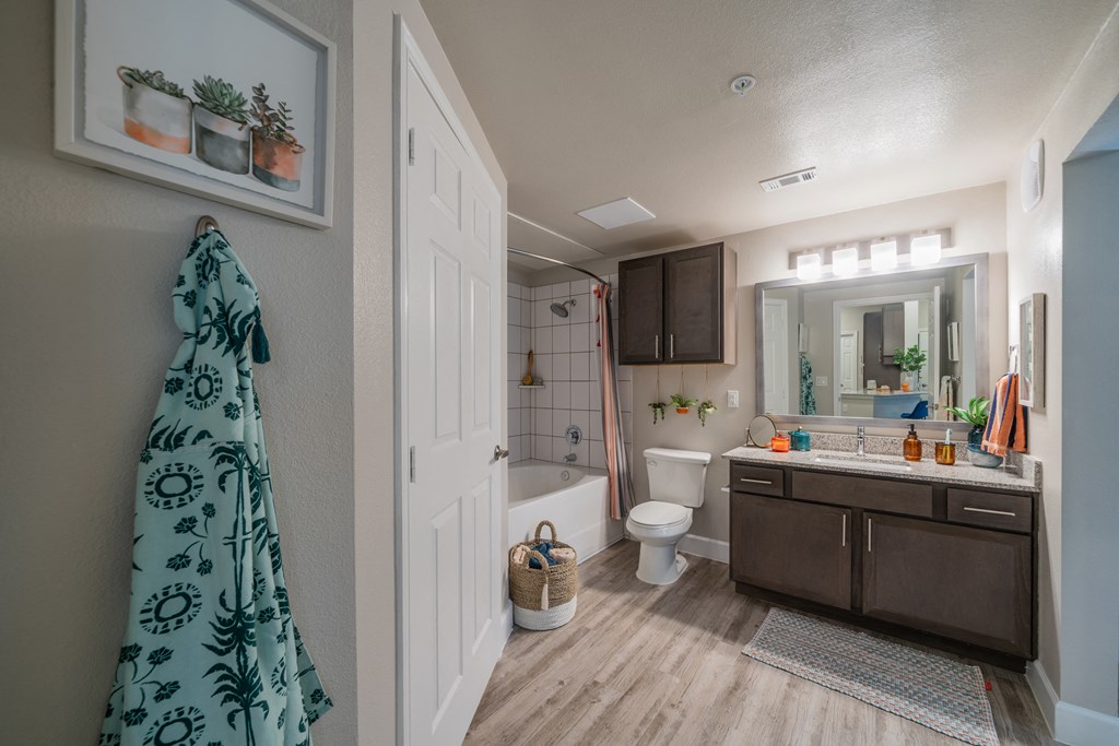 a bathroom with a white toilet next to a bathtub