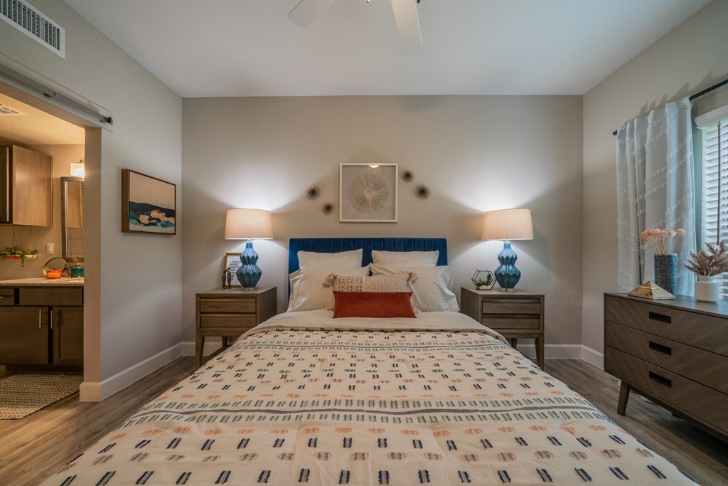 a bedroom with a bed and two nightstands