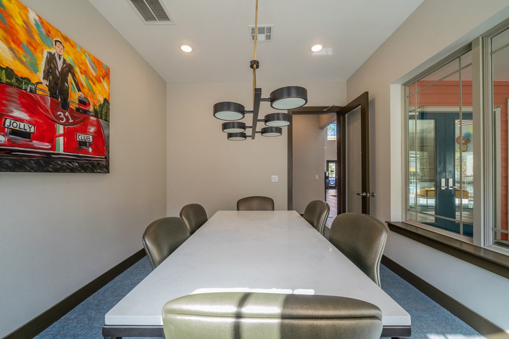 a conference room with a long table and chairs