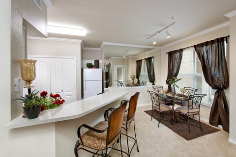 A dining room with a table set for four.