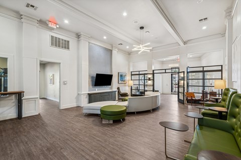 A spacious living room with a green couch and a television.