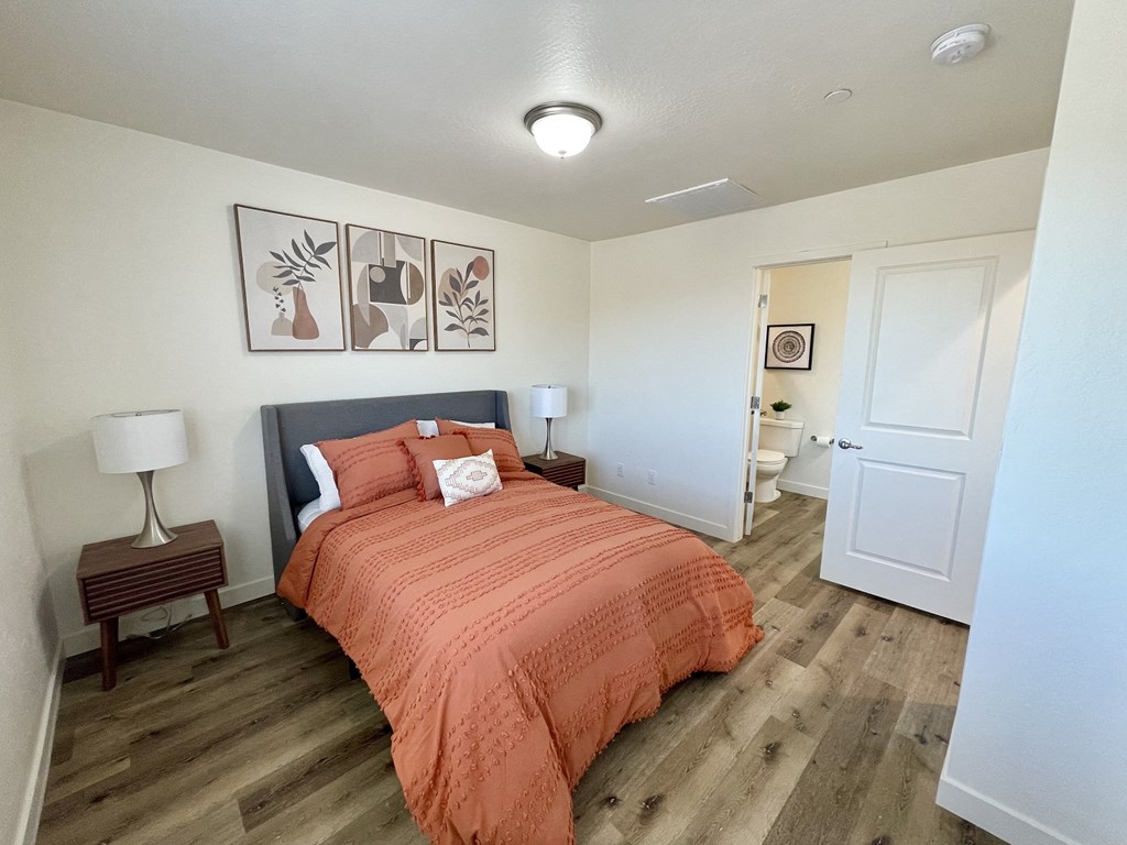an overhead view of a bedroom with a bed and a bathroom