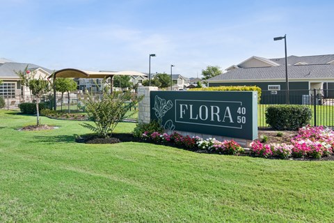 A sign that says "FLORA 40" is in front of a building.
