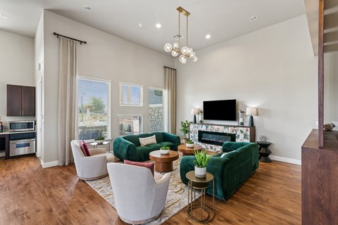 A living room with a green couch and a fireplace.