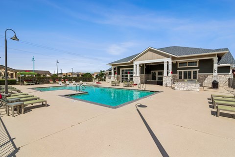 A large swimming pool with a building in the background.