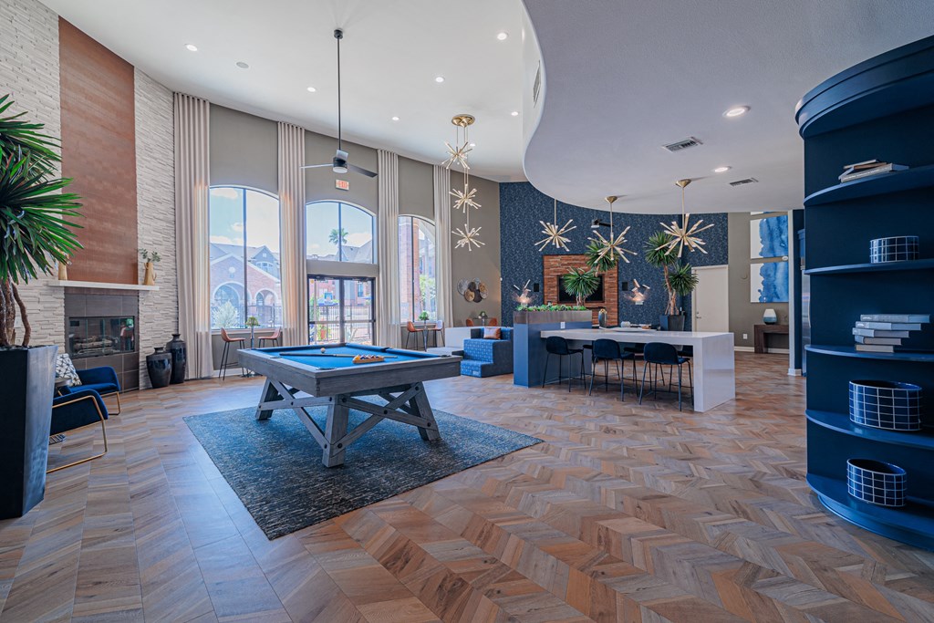 a spacious game room with a pool table and ping pong table