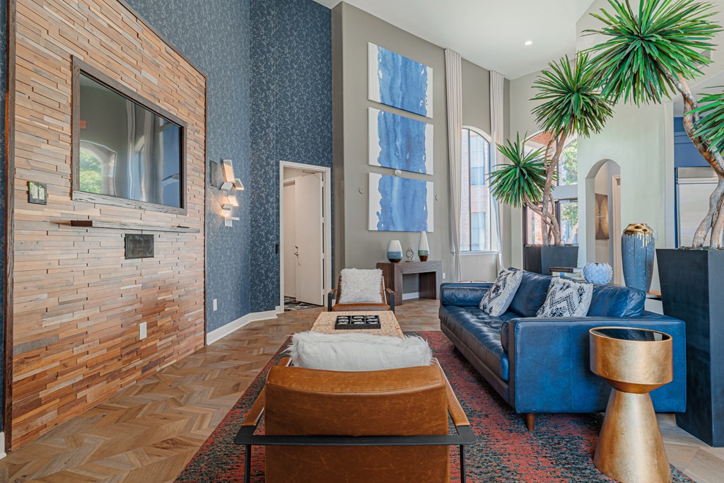a living room with blue walls and a brick fireplace