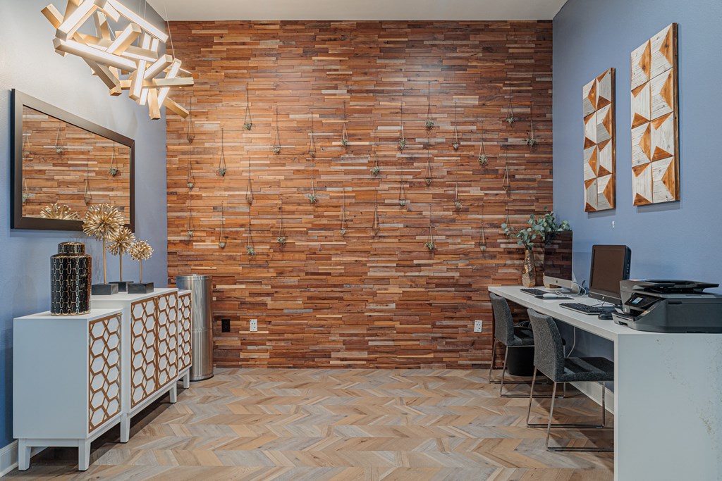an office with a brick wall and wood flooring