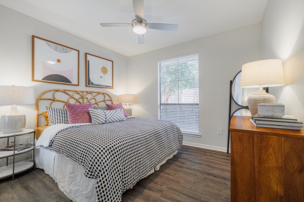 a bedroom with a large bed and a ceiling fan
