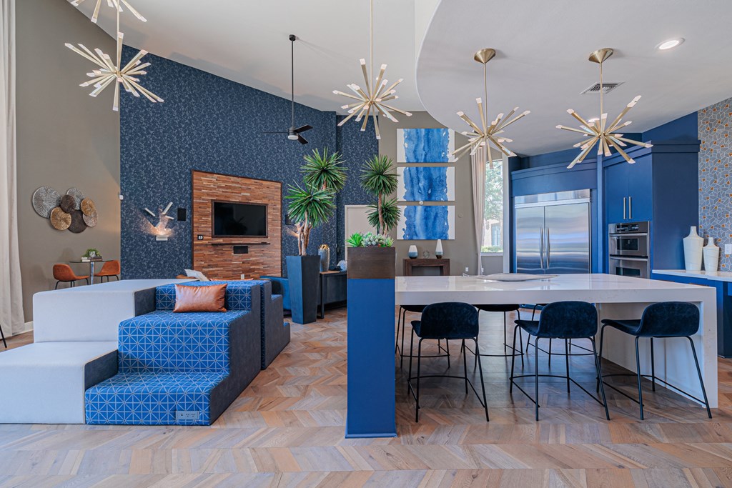 a blue and white living room with blue chairs and a white table