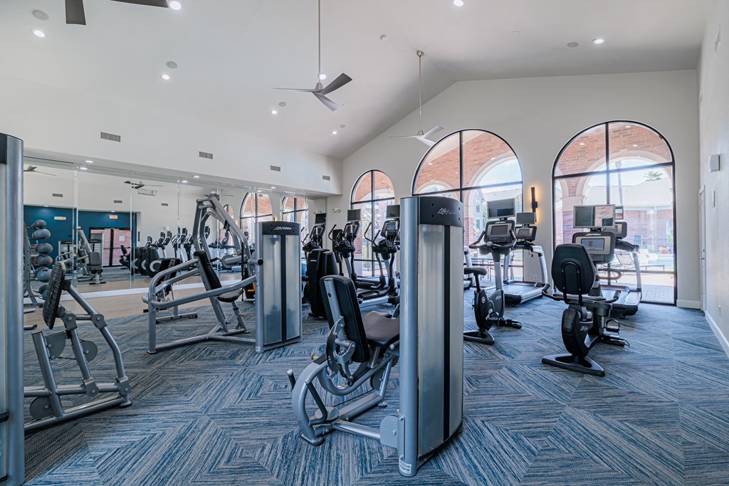 a gym with cardio machines and other exercise equipment
