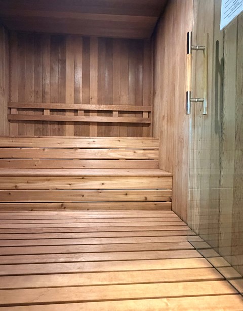 A wooden staircase with a glass door at the top.