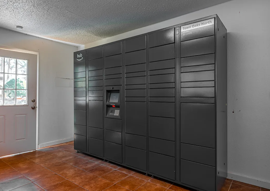 a large black refrigerator in a room with a door