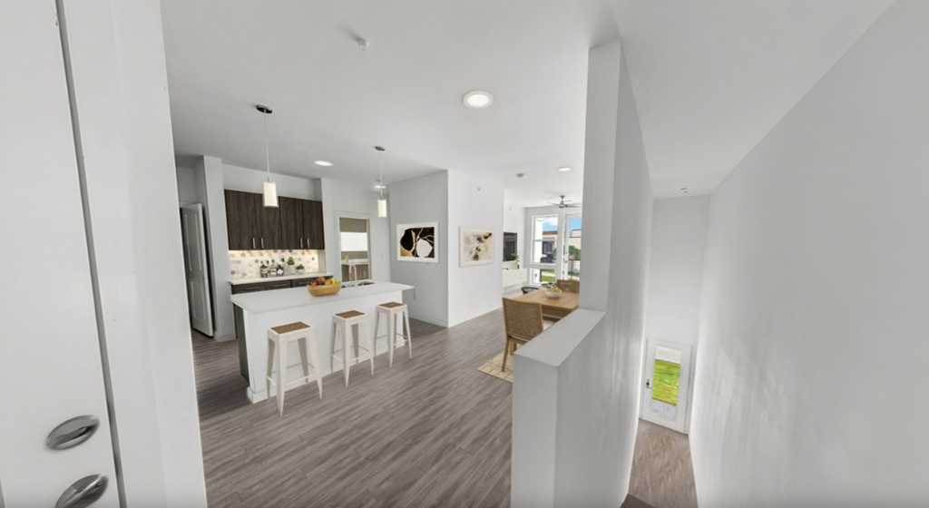 a kitchen and dining area with white walls and wood floors