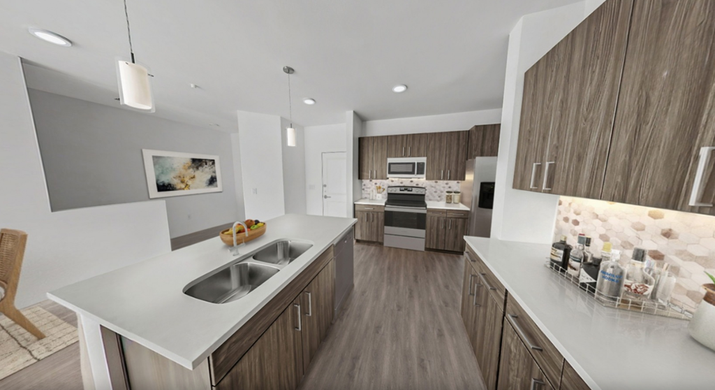 a kitchen with wooden cabinets and white counter tops in a modern apartment