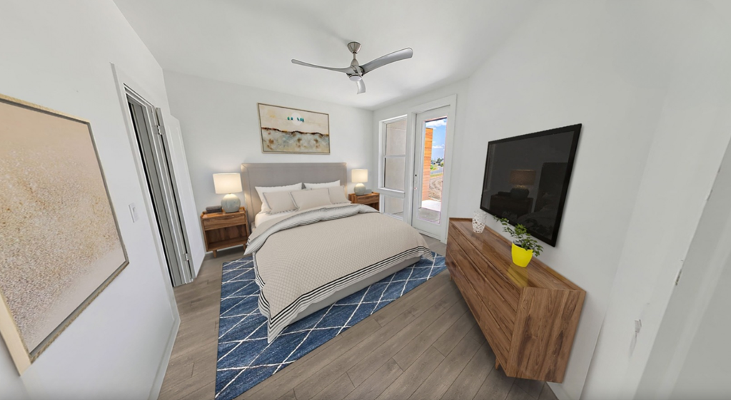 a bedroom with a bed and a tv