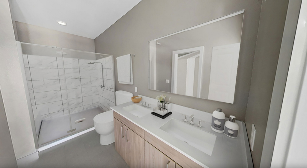 a bathroom with a sink and a shower and a toilet