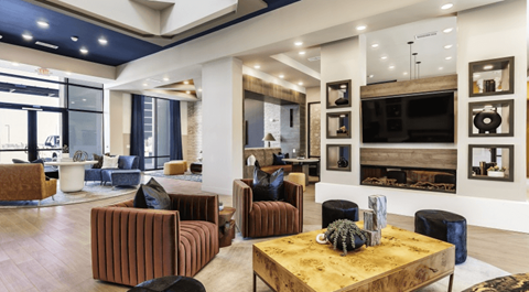 A modern living room with a wooden coffee table and a fireplace.