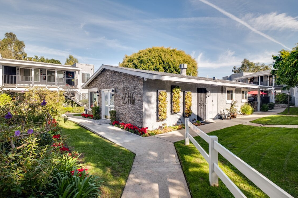 a house with a garden and a white fence
