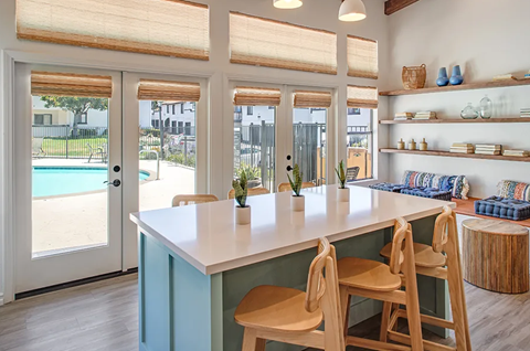 a kitchen with a table and chairs next to a pool
