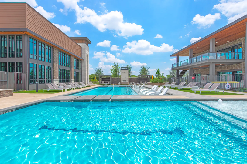a swimming pool with a building in the background