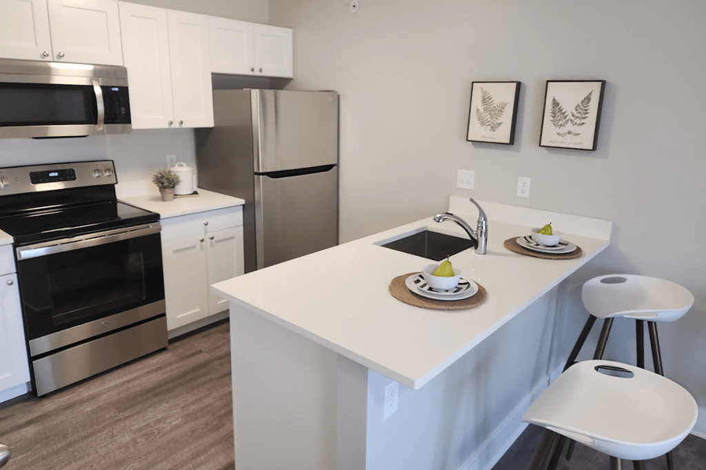 a kitchen with stainless steel appliances and a white counter top