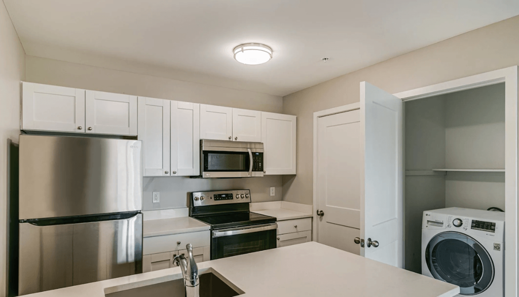 a kitchen with stainless steel appliances and white cabinets