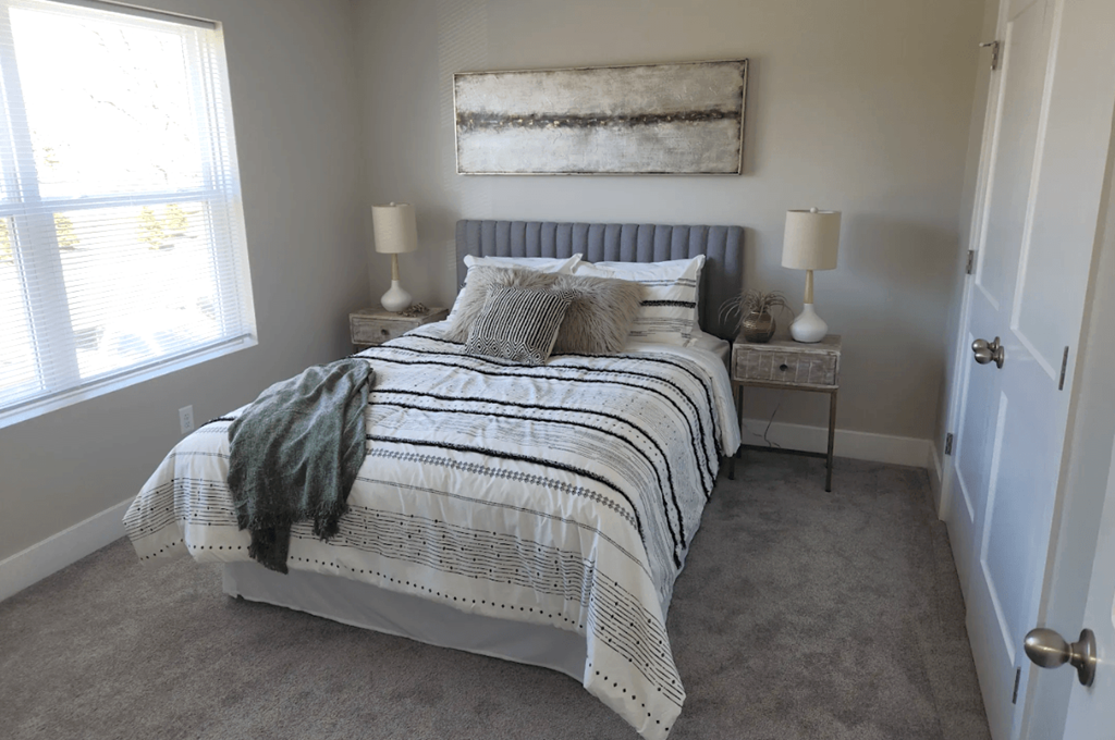 a bedroom with a bed and a window