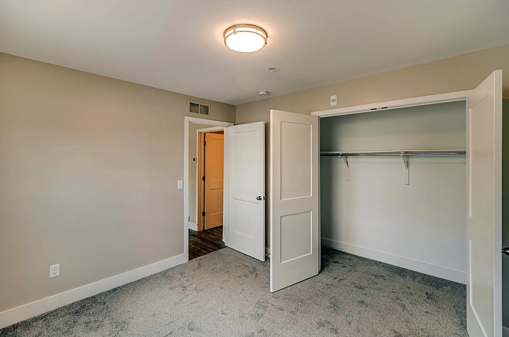 a bedroom with a closet and a door to a closet