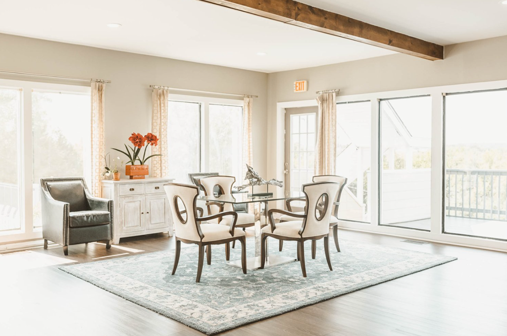 a dining room with a table and chairs and a rug