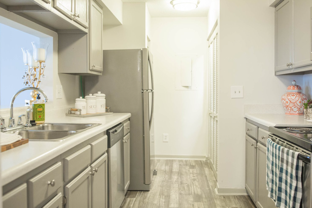 a kitchen with stainless steel appliances and white counter tops