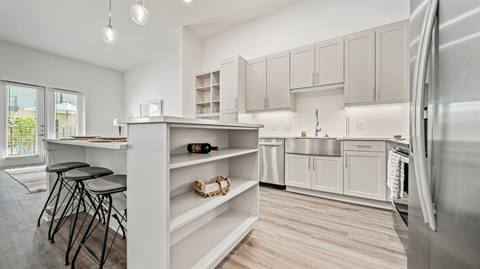 A modern kitchen with a dining table and chairs.