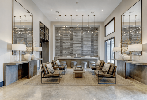 A modern living room with a large window and a long table.