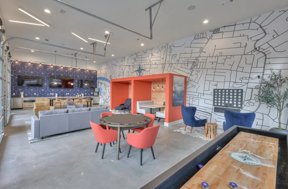 A room with a table and chairs in front of a wall with a map on it.