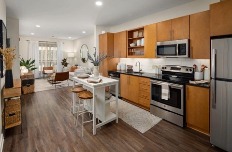 A modern kitchen with wooden cabinets and a white island.