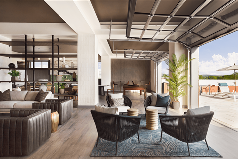 A modern living room with a large sofa set and a wooden floor.