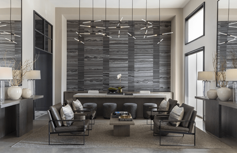 A modern living room with a large sectional sofa and a coffee table.