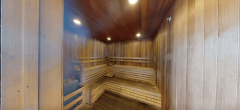 A row of wooden benches are lined up in a sauna.