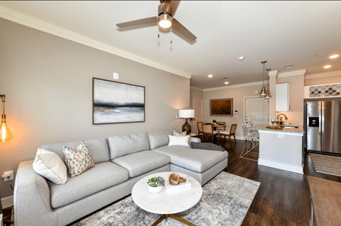 A modern living room with a grey sofa and a coffee table.